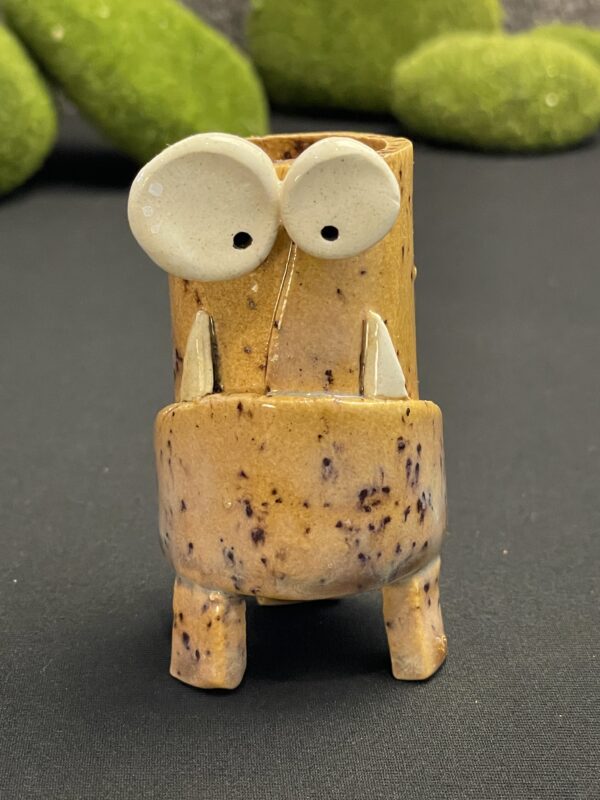 Speckled tan mini monster pot with legs.